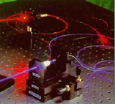 A picture of a laser coupling light into a optical fiber in the lab